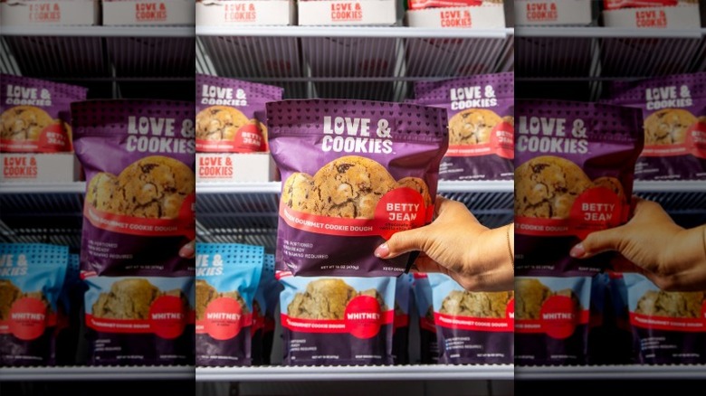 Person holds packet of Love & Cookies Frozen Gourmet Cookie Dough