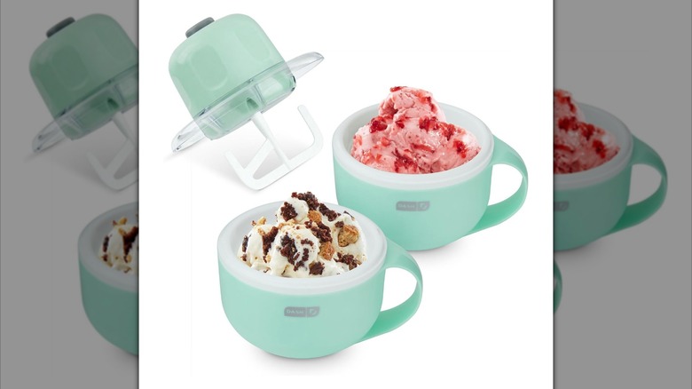 Dash My Mug Ice Cream Maker paddle next to mug-shaped cannisters in aqua color holding strawberry and chocolate cookie ice creams