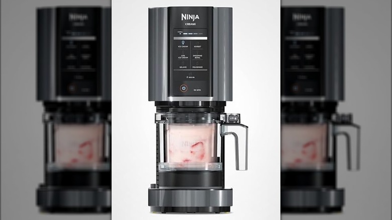 Ninja CREAMi Ice Cream Maker with pitcher full of pink ice cream on light gray background