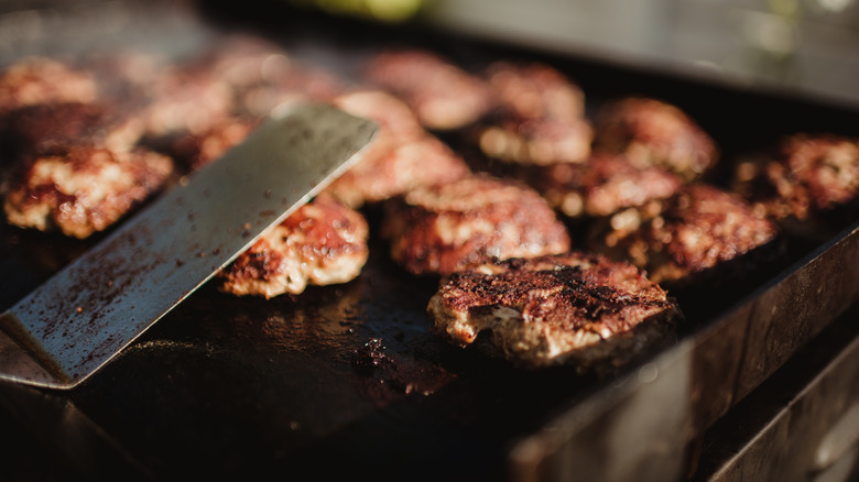 meat cooking on flat grill