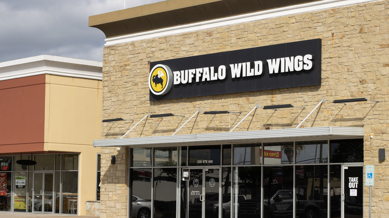 The exterior of a Buffalo Wild Wings location that has a black sign with white letters