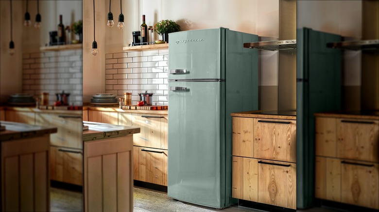 A mint green Frigidaire retro-style compact refrigerator in a kitchen
