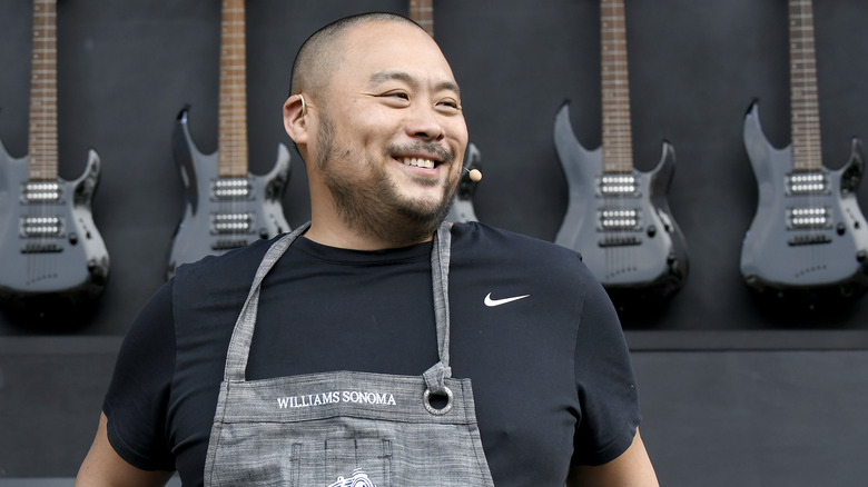 David Chang in front of guitars