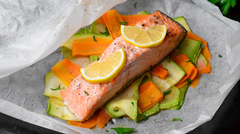 steamed salmon with lemon over vegetables