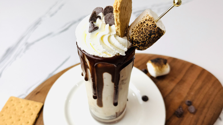 Decadent s'mores milkshake with marshmallow and graham cracker garnish