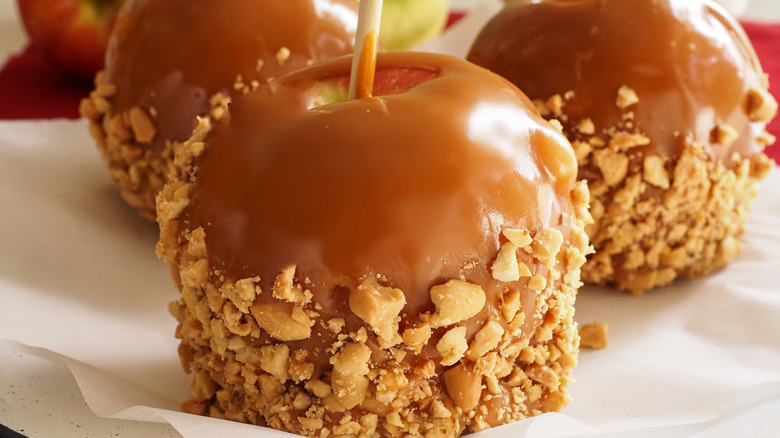 Closeup view of homemade caramel apples on parchment paper