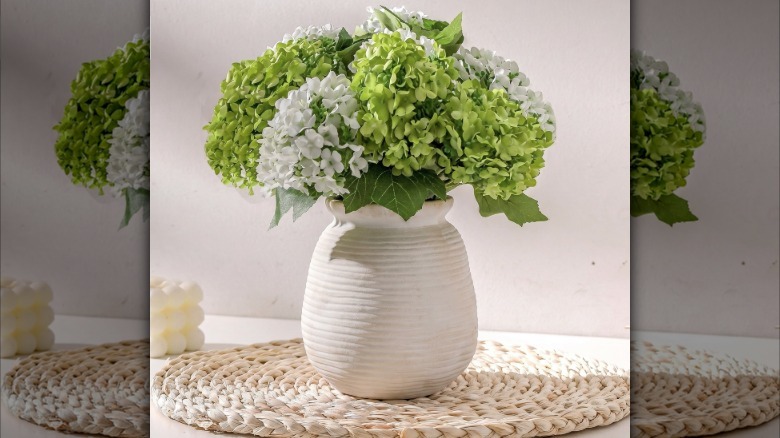 Flower vase with fake flowers in it