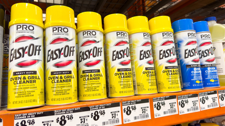 Cans of yellow and blue Easy-Off Pro sitting on a shelf at a Home Depot store