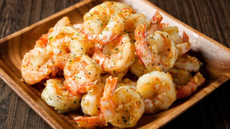 fried shrimp on a wood platter