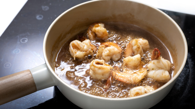 shallow frying shrimp in a sauce pan