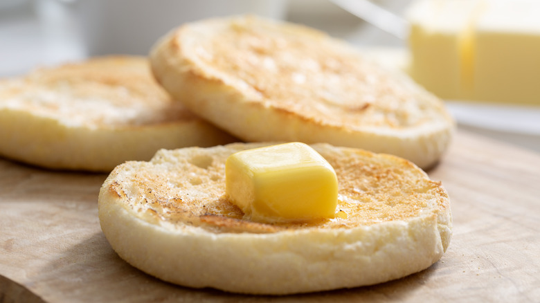 Open-face english muffins sliced with butter