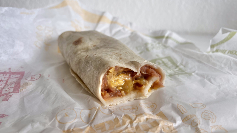 Bean & Cheese Burrito with Green Sauce on a paper wrapper