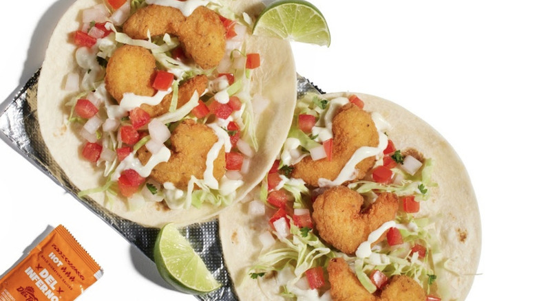 Del Taco shrimp tacos on a white background