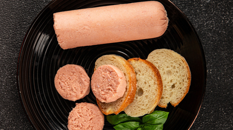 Liverwurst beside slices of sandwich bread