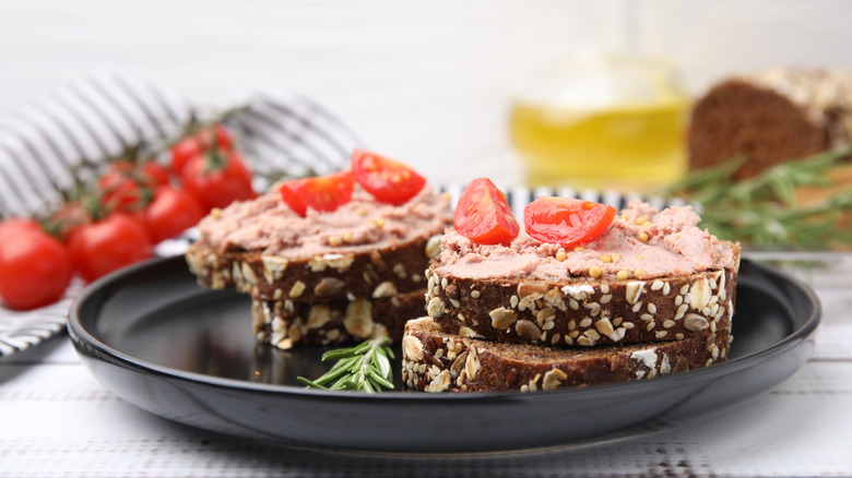 Close-up of a liverwurst sandwich on whole grain bread with tomatoes