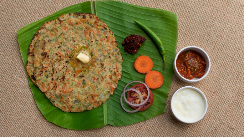 rice roti on leaf with condiments