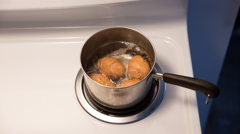 4 eggs boiling in pot