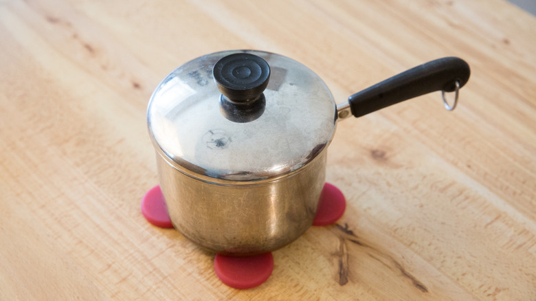 covered saucepan on wooden table