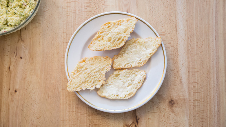 buttered croissants on white plate