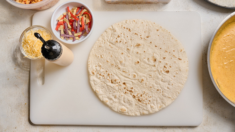 warmed tortilla on a cutting board