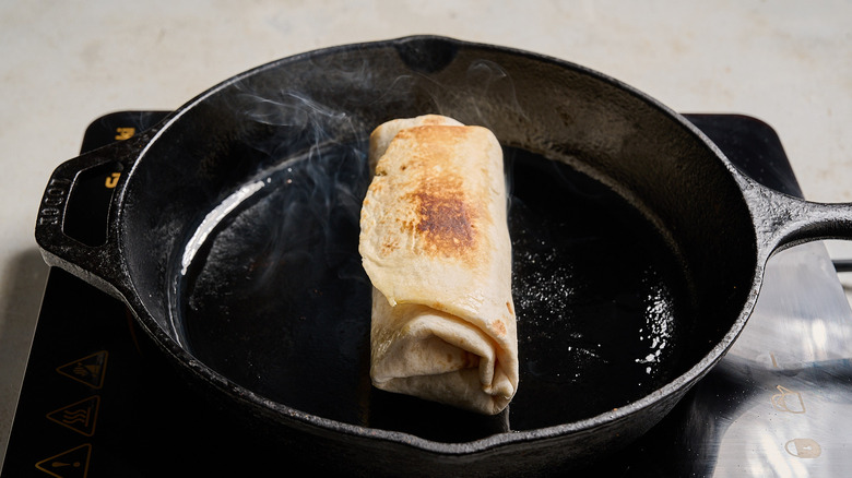 toasting the exterior of the burrito