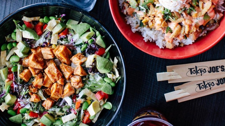 Two Tokyo Joe's bowls with branded chopsticks beside them