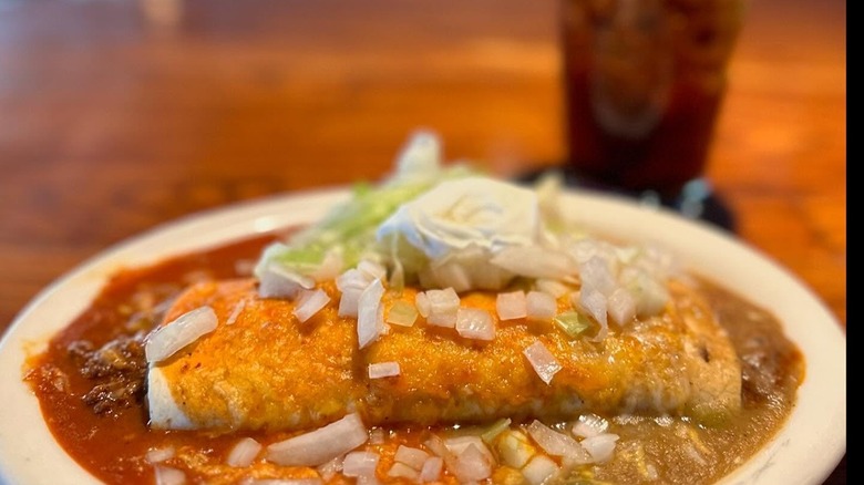 A burrito smothered in both green and red chile sauces at La Fogata