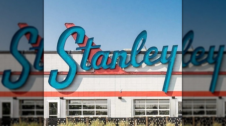 A blue sign that says "Stanley" over a white building