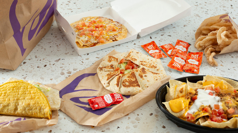Taco Bell meal featuring nachos, a Mexican pizza, and tacos