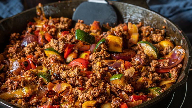 Ground beef with peppers and veggies in pan