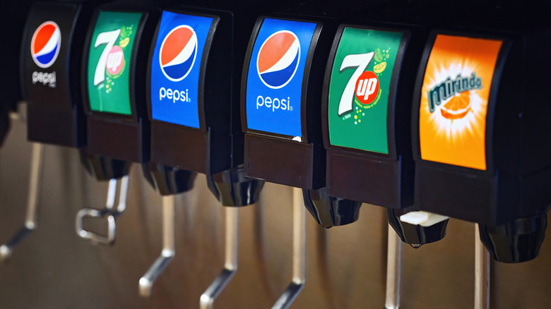 close up of soda machine with different varieties