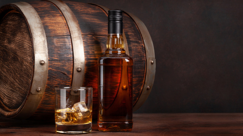bourbon bottle pictured with barrel