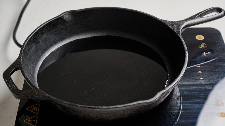 heating oil in a skillet on a stove