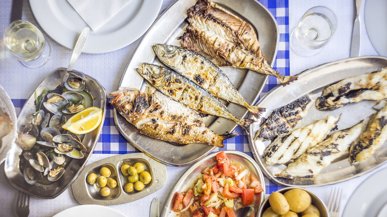 A Portuguese meal of fish, olives, clams, and tomatoes