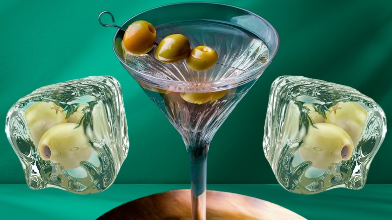 Martini glass with olives, ice cubes with olives inside
