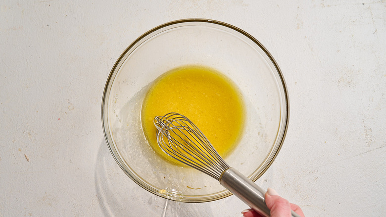 whisking marinade in a bowl
