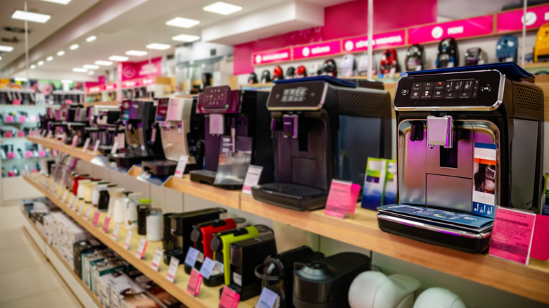 A line of espresso machines on a store shelf