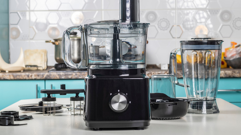 A blender and a food processor in a kitchen.