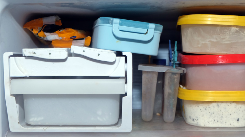 A freezer compartment filled with several sealed containers