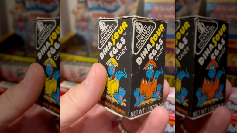 hand holding DinaSour Eggs candy in a box