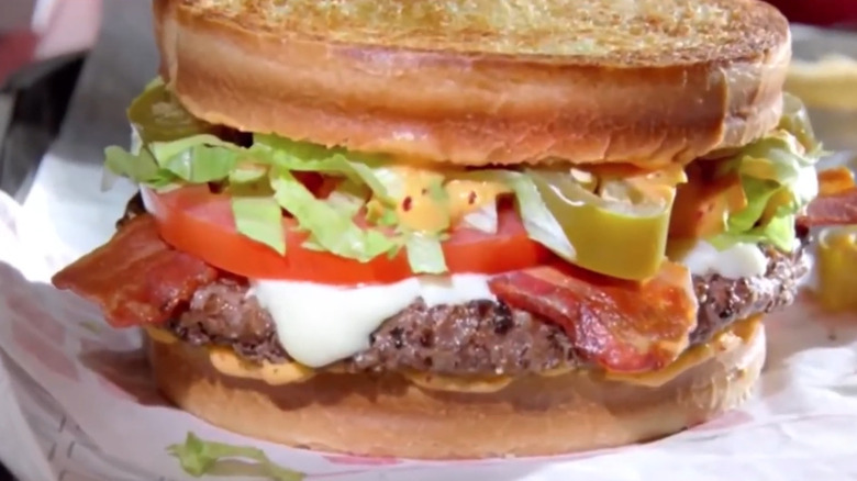 Jack in the Box spicy sriracha burger on paper