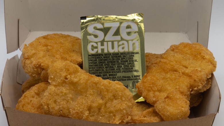 A container of McDonald's Szechuan Sauce with McNuggets