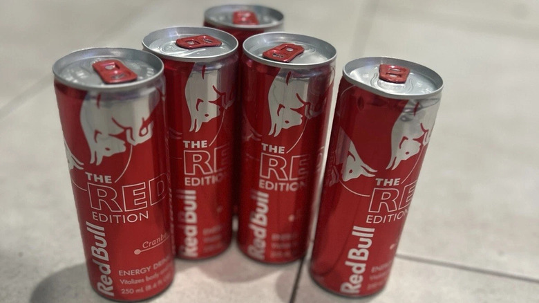 Group of Cranberry Red Edition Red Bull cans on tiles