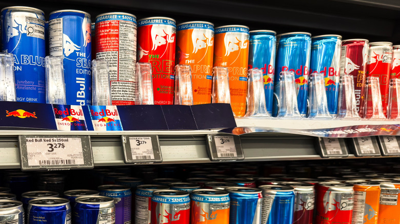 Assorted cans of Red Bull on grocery store shelf