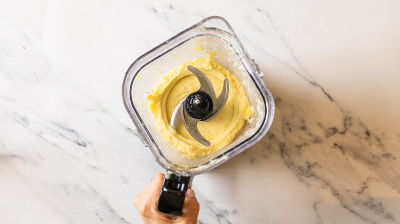 Blended Dole Whip ice cream in blender.