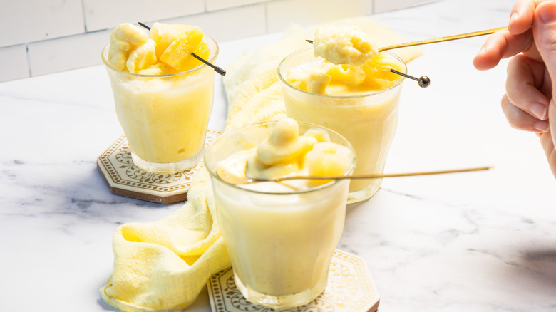 A person lifting a spoonful of a Dole Whip float.
