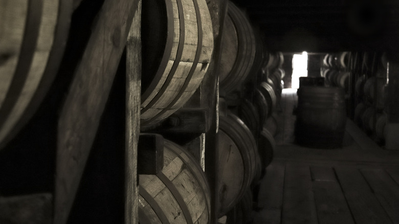 Barrels stored on their side in a multi-story wooden rickhouse