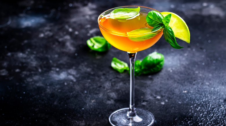 A cocktail garnished with basil