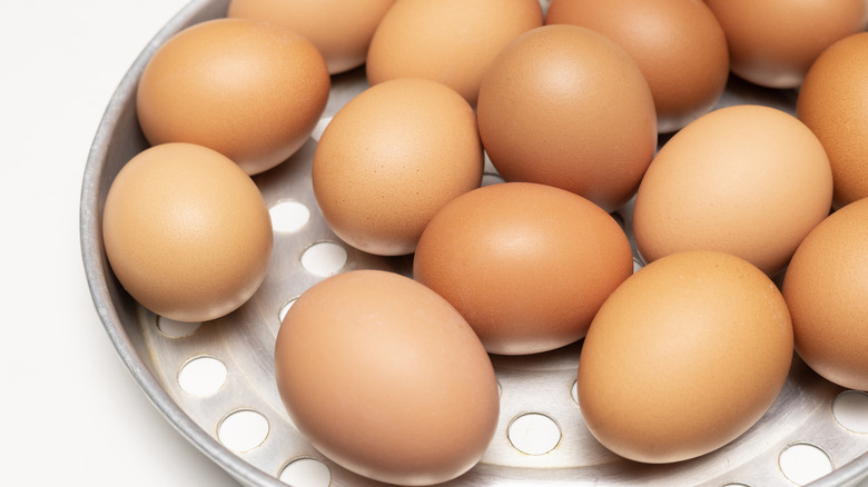 Chicken eggs on steamer basket.