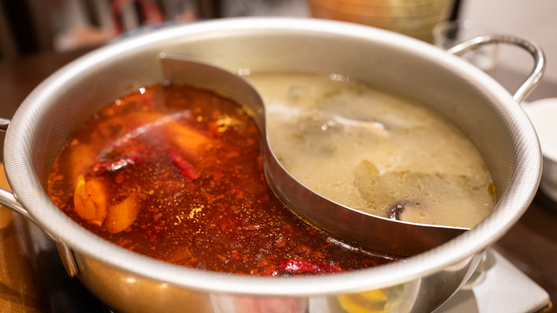 Closeup overhead view of divided hot pot with stews